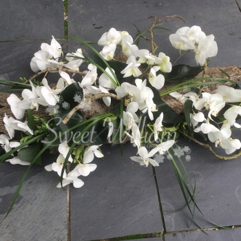 Orchid and bark casket spray